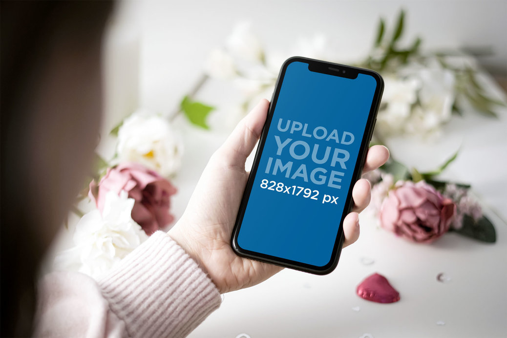 Mockup of a Woman Holding an iPhone 11 by Some Valentine's Day Gifts