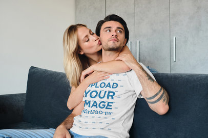 T-Shirt Mockup of a Man With Arm Tattoos Posing With His Girlfriend at Home 