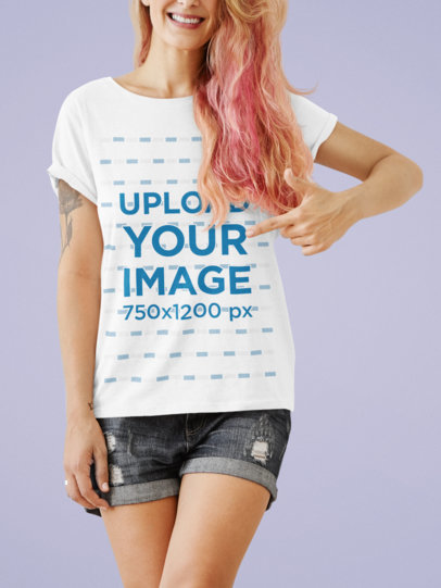 Mockup of a Happy Woman Pointing at Her T-Shirt at a Studio