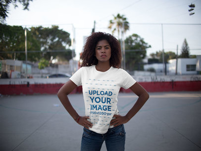 Young Woman with her Hands on her Waist Standing Outdoors While Wearing a T-Shirt Template