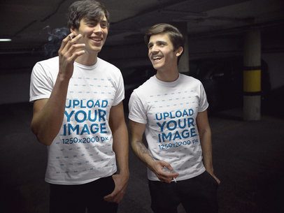 Two Friends Wearing T-Shirts Mockup While Having a Smoke in the Parking Lot a15740