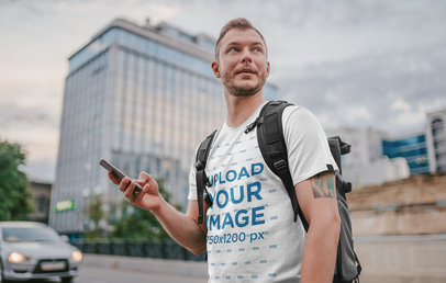 T-Shirt Mockup of a Tattooed Traveler Exploring a City