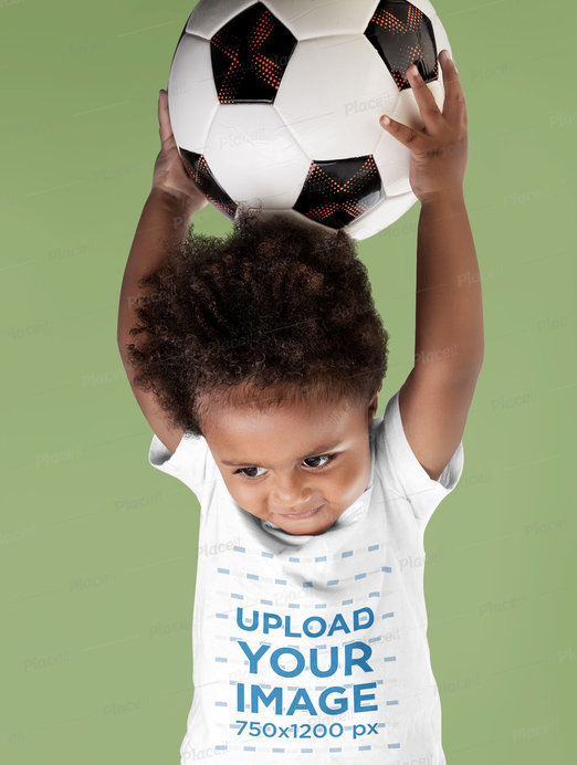 T-Shirt Mockup of a Little Boy Holding a Soccer Ball