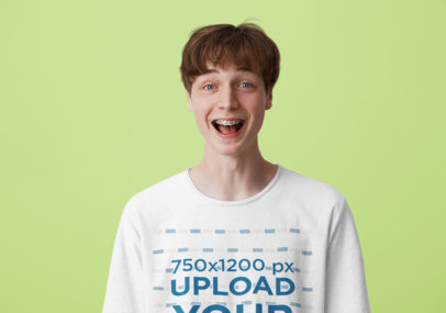 T-Shirt Mockup of a Young Man with a Big Smile in a Studio