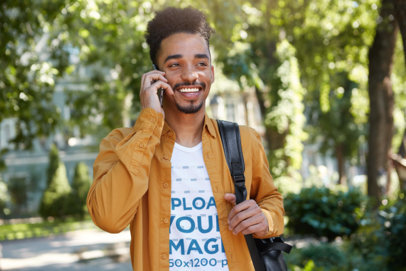 V-Neck Tee Mockup of a Happy College Man Talking on the Phone