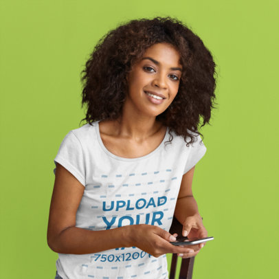 T-Shirt Mockup of a Woman Sitting in a Studio