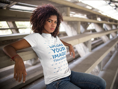 Mockup of a Young Woman Wearing a Round Neck T-shirt While Sitting Down in a Big Stairway 