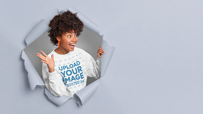 Sweatshirt Mockup of a Cheerful Woman Coming Through a Paper Wall