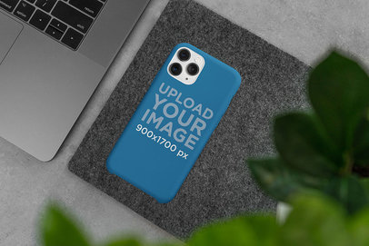 Mockup of a Phone Case Placed on a Surface Next to a Computer
