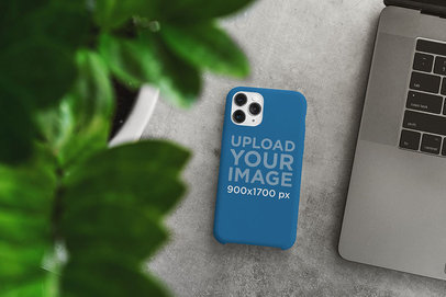 Mockup of a Phone Case Placed on a Desk Next to a Computer