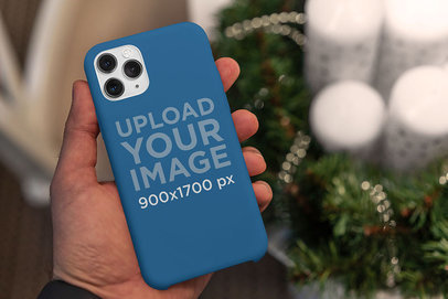 Christmas-Themed Mockup of a Man Holding a Phone Case