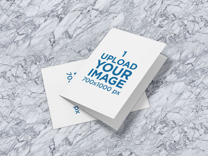 Mockup of Two Bifold Greeting Cards Placed on a Customizable Surface