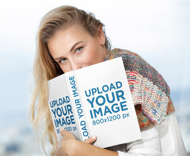 Mockup of a Woman Holding a Hard-Cover Book