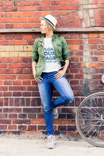 T-Shirt Mockup of a Relaxed Woman Posing by a Brick Wall