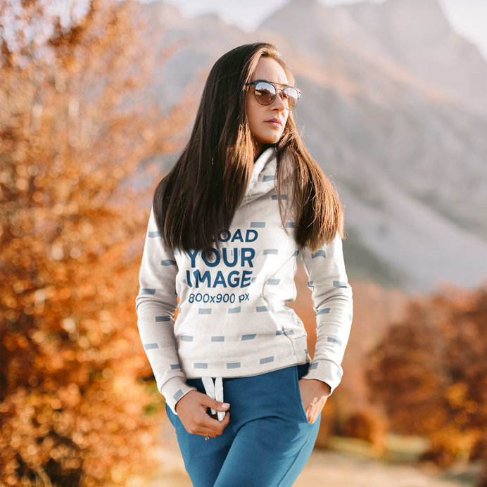Hoodie Mockup Featuring a Woman Posing by a Mountain