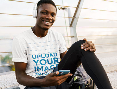 T-Shirt Mockup of a Man Listening to Music With Headphones