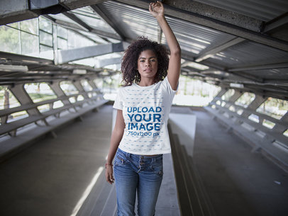 Mockup of a Young Woman Wearing a T-Shirt While Walking in the City 