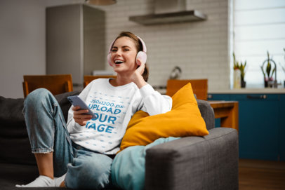 Crewneck Sweatshirt Mockup Featuring a Woman Listening to Music at Home