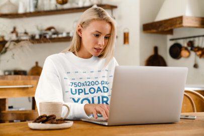 T-Shirt Mockup of a Woman Working From Her Kitchen