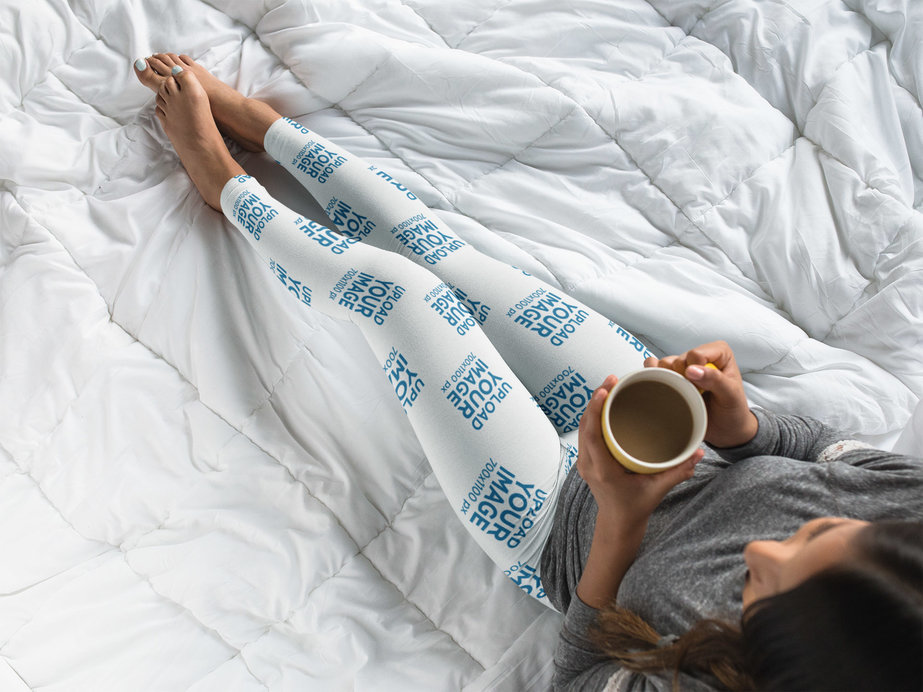 Top Shot of a Young Woman Wearing Leggings Mockup While on Her Bed