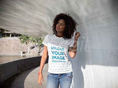 Mockup of a Young Woman Holding her Hair Under a Tunnel While Wearing a Round Neck T-Shirt