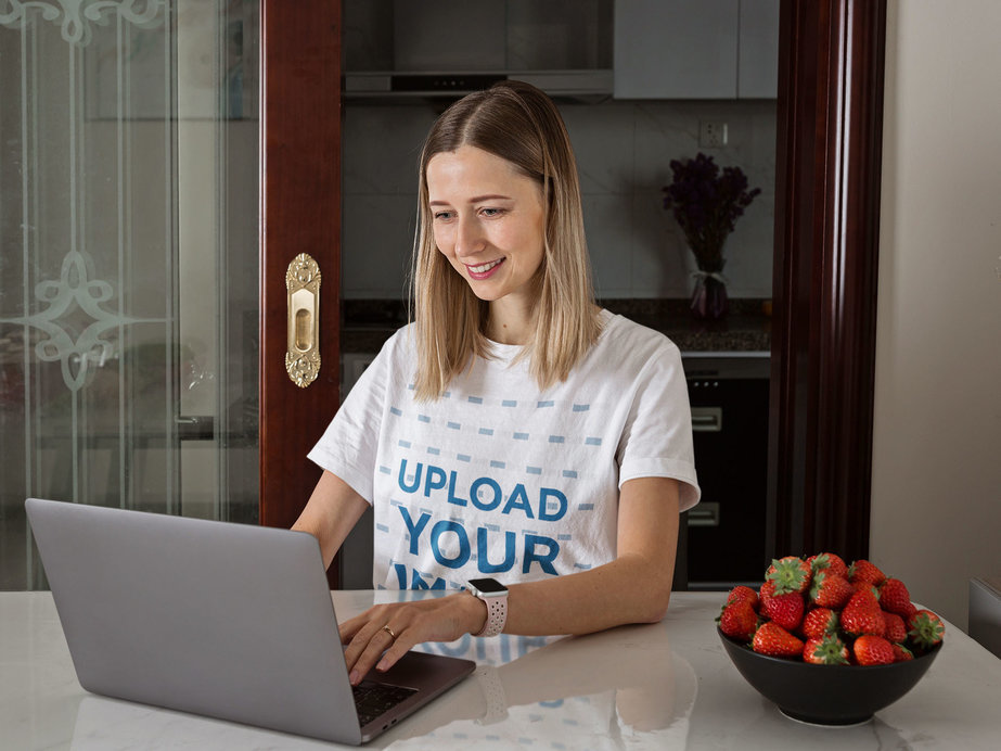 Unisex T-Shirt Mockup Featuring a Woman Working at Home