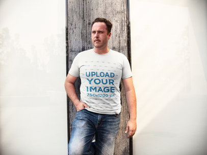 Mockup of a White Man Standing Between Two Windows While Wearing a Round Neck Tshirt