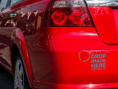 Mockup of a Sticker on the Back Bumper of a Red Car