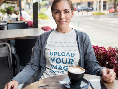 Middle Aged Woman Wearing a Round Neck T-Shirt Mockup While at a Cafe