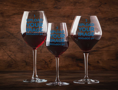 Mockup Featuring Three Customizable Wine Glasses Against a Wooden Background 