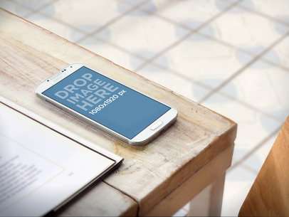 Galaxy 4 Mockup Featuring the Edge of a Wooden Table