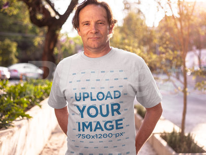 Middle Aged Man Wearing a Round Neck Tshirt Mockup While Standing Against the Sun