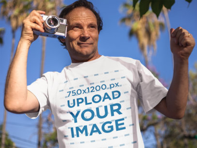 White Middle Aged Man Wearing a Round Neck T-Shirt Mockup While Taking Pictures Outdoors
