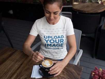 Middle Aged Woman Wearing a T-Shirt Mockup While at a Cafe