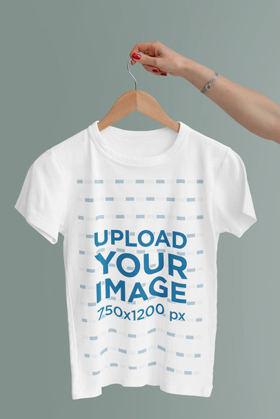 Mockup of a Woman's Arm Holding a Hanged T-Shirt