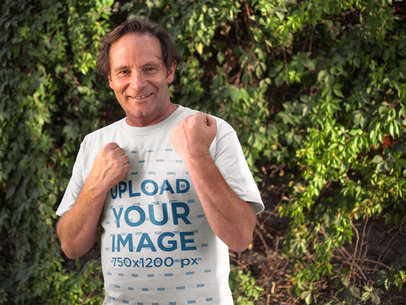 Smiling Middle Aged Man in Fighting Position Wearing a Round Neck Tee Template