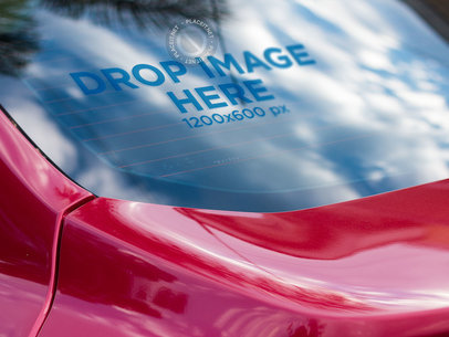 Red Car with a Window Decal Mockup on the Back Window Reflecting Clouds