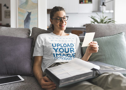 T-Shirt Mockup of a Woman Looking At Some Old Pictures 