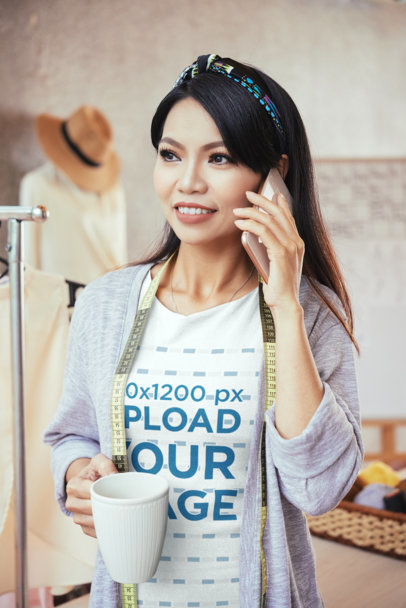 T-Shirt Mockup of a Seamstress Talking on the Phone While Having a Coffee M4217-r-el2