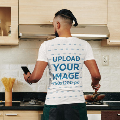 Back-View Tee Mockup of a Man Cooking a Meal at Home