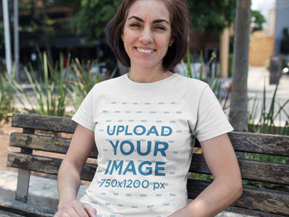 Happy Middle Age Woman Wearing a T-shirt Template While Sitting on a Bench