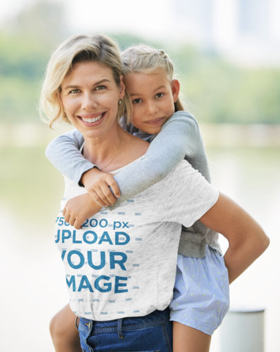 Mother's Day Mockup Featuring a Happy Woman With a Heathered T-Shirt Carrying Her Daughter