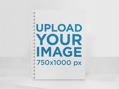 Frontal Shot of a Spiral Notebook Mockup Standing on a Multicolor Room a15309