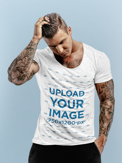 Mockup of a Muscular Tattooed Man Wearing a Heather T-Shirt