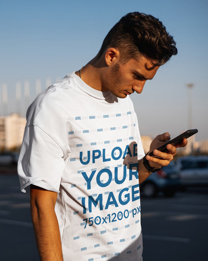 T-Shirt Mockup of a Serious Man Checking His Phone 