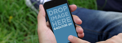 Mockup of a Finger Touching a Black iPhone 5 in Portrait Mode