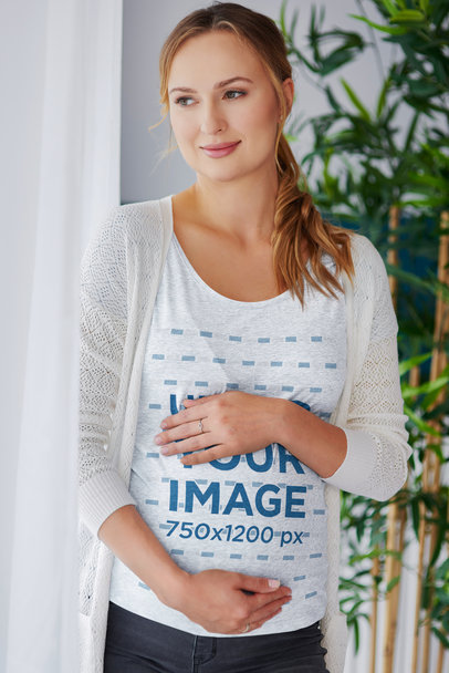Heather T-Shirt Mockup of a Pregnant Woman Looking Out the Window