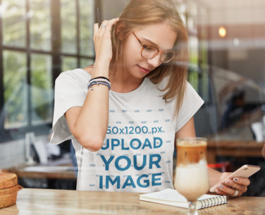 T-Shirt Mockup Featuring a Woman With Glasses at a Cafe m3200-r-el2