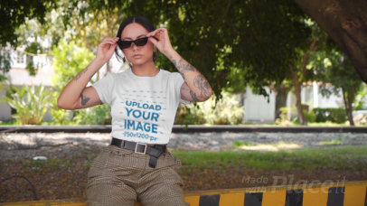 T-Shirt Video Maker Featuring a Tattooed Woman With Sunglasses Winking 