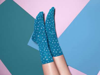 Pair of Socks Mockup Being Worn While Against a Tricolor Surface a15595